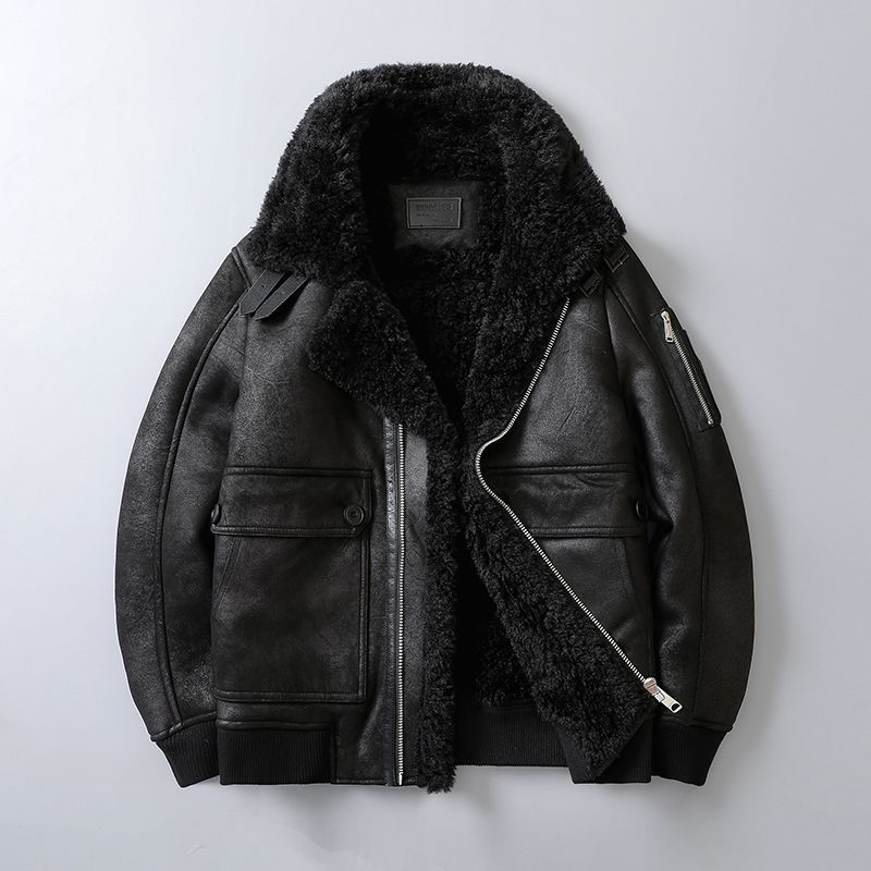 A black leather shearling jacket with plush lining, a wide shearling collar, zip front, and ribbed cuffs, shown flat