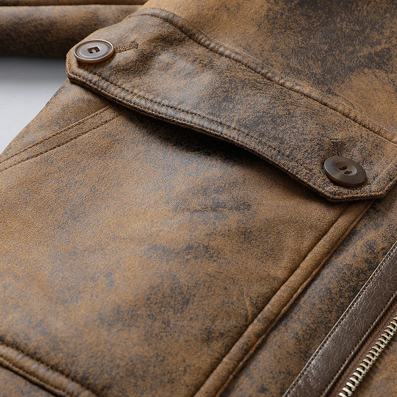 Close-up of a brown leather shearling jacket showing the plush-lined collar and leather buckle detail