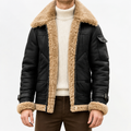 A person wearing a black leather shearling jacket with sherpa lining, a wide collar, zip front, and biker-inspired style