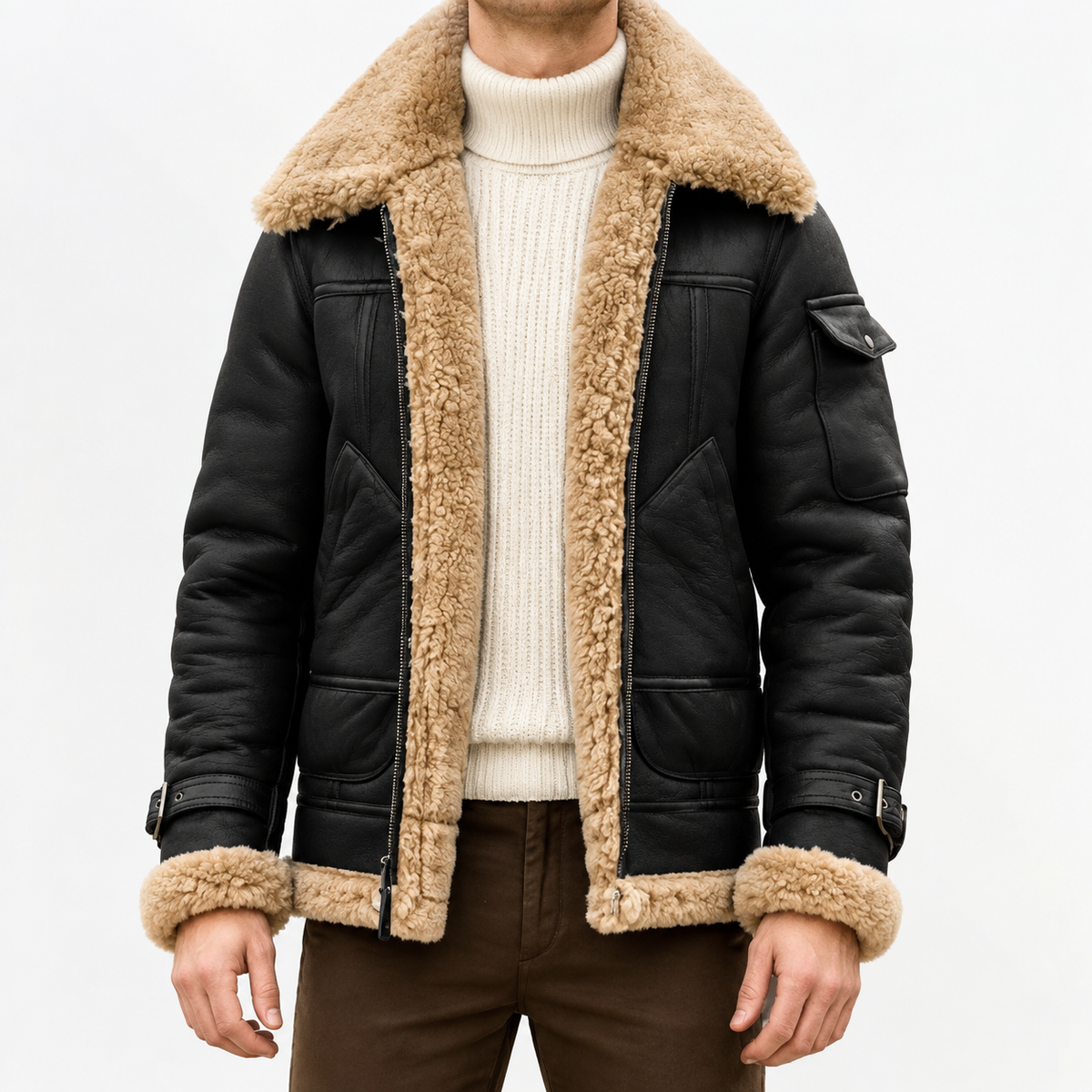 A person wearing a black leather shearling jacket with sherpa lining, a wide collar, zip front, and biker-inspired style