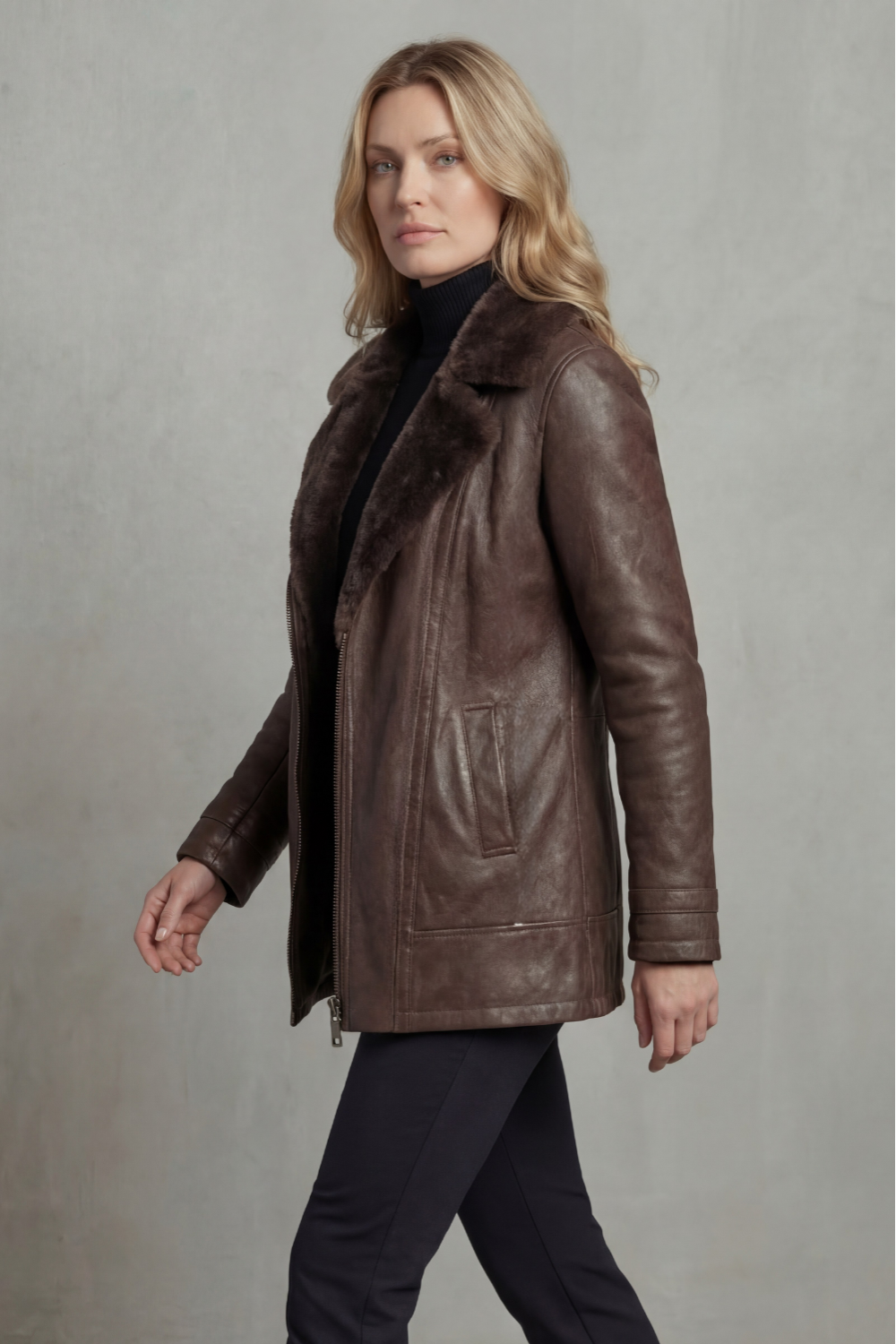 Dark Brown leather shearling jacket for women worn by a female model, side view with a tailored fit and plush shearling collar