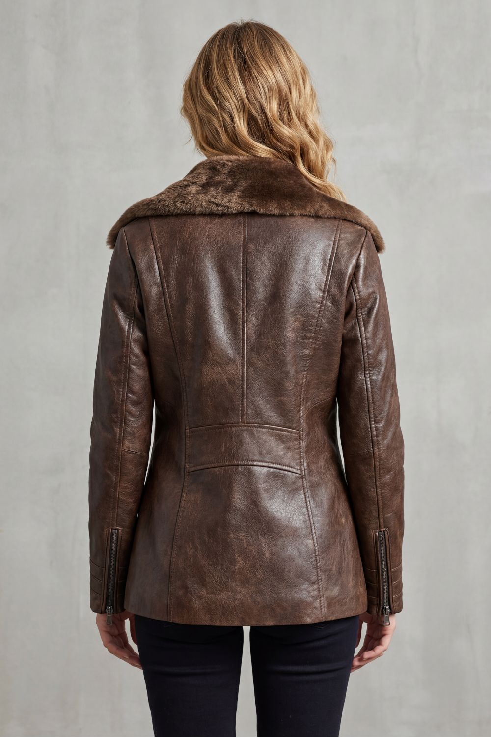 Dark Brown leather shearling jacket for women worn by a female model, back view with a tailored fit and smooth leather finish
