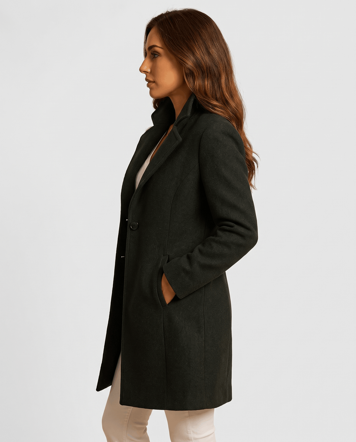A woman wearing a black long wool coat with a slim fit and notch collar, shown in side view