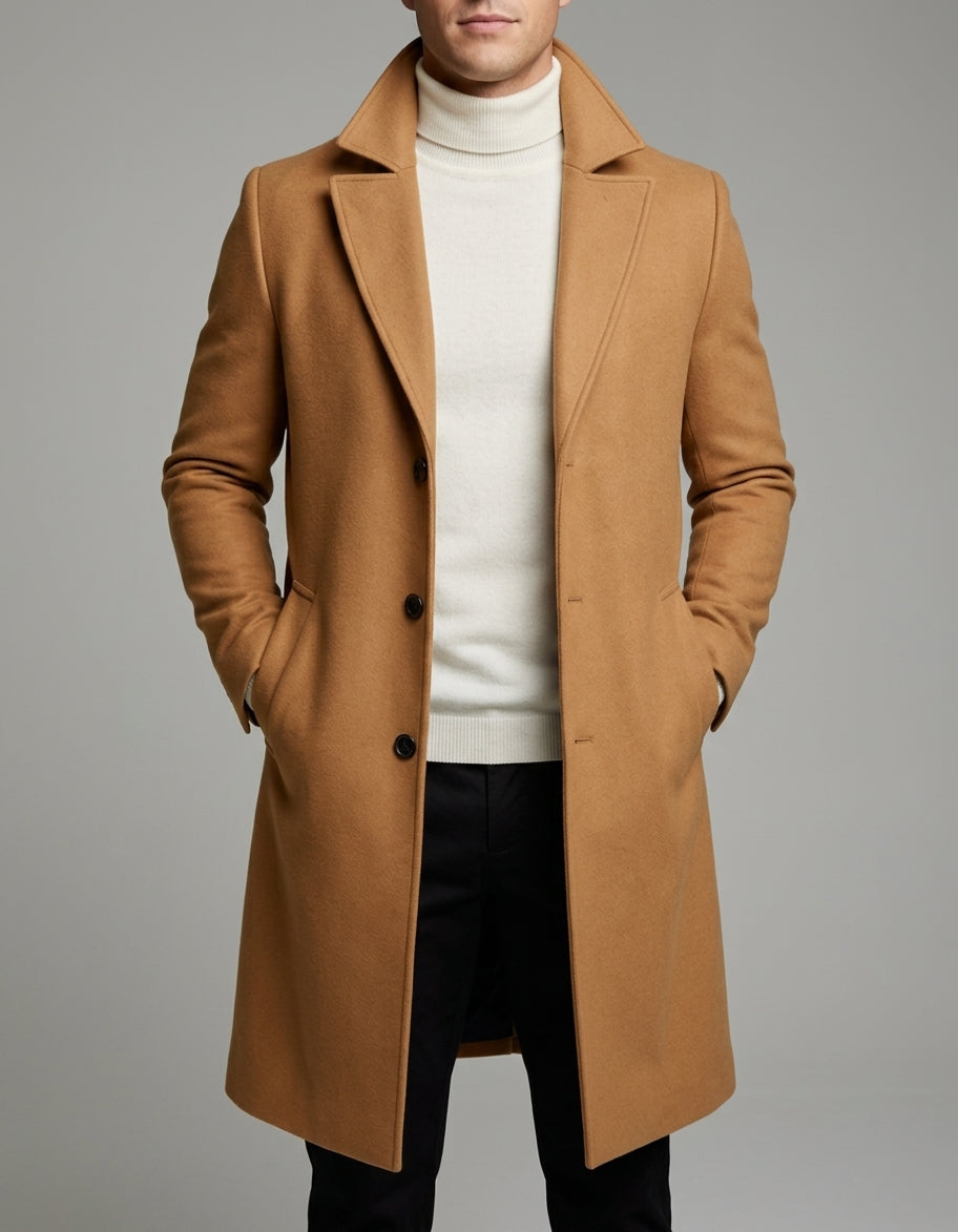 A man wearing a camel brown long wool overcoat with a notch lapel and single-breasted fit