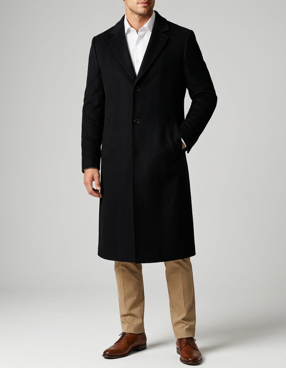 A man wearing a black long wool overcoat with a notch lapel and single-breasted fit