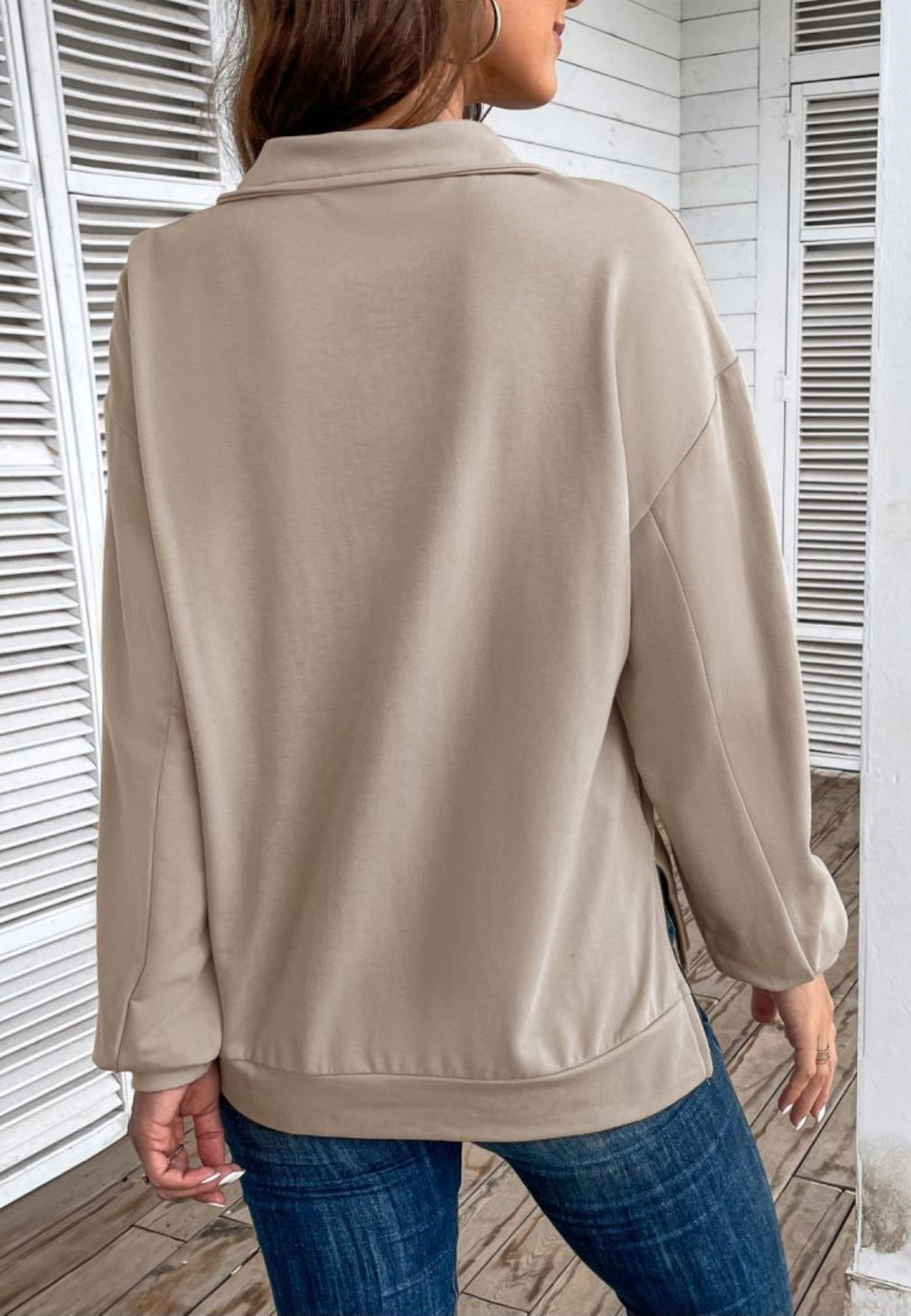 Taupe loose fit quarter-zip sweater shown from the back with long sleeves and a relaxed silhouette