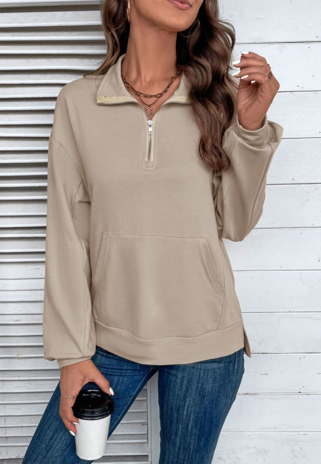 Taupe loose fit quarter-zip sweater worn by a female model, front view