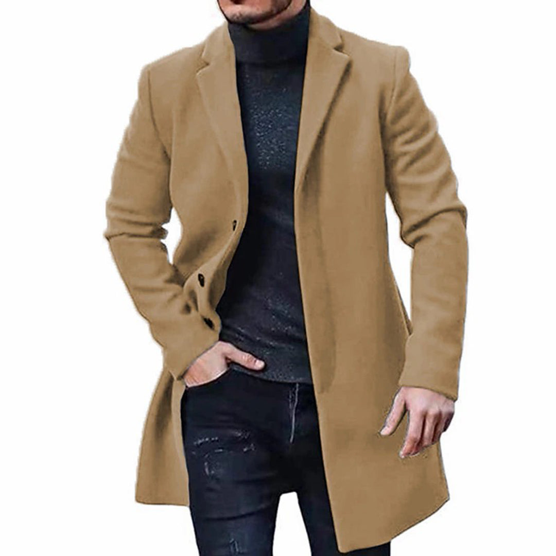 A man wearing a brown mid-length wool coat with a single-breasted front and tailored fit