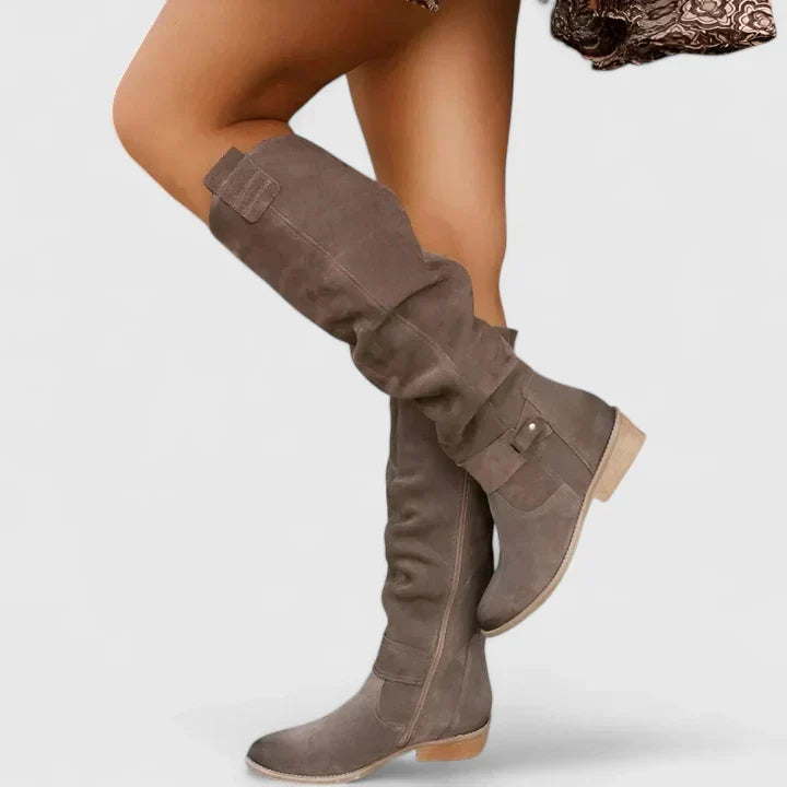 Taupe suede over-the-knee boots with a slouchy shaft, almond toe, side zip, and low block heel.