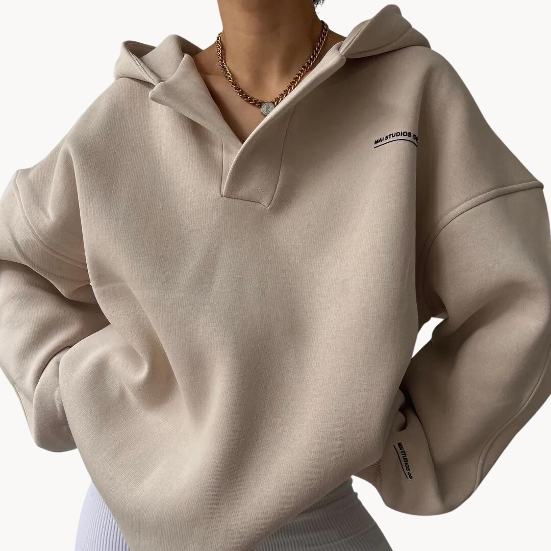 Light Beige oversized fleece hoodie for women with a drop shoulder, collared neckline, kangaroo pocket, and relaxed fit
