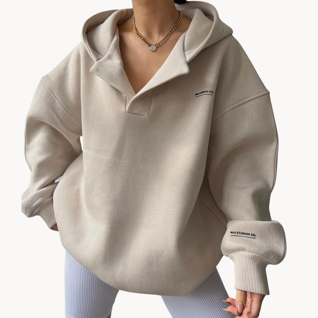 Light Beige oversized fleece hoodie for women with a drop shoulder, collared neckline, kangaroo pocket, and relaxed fit