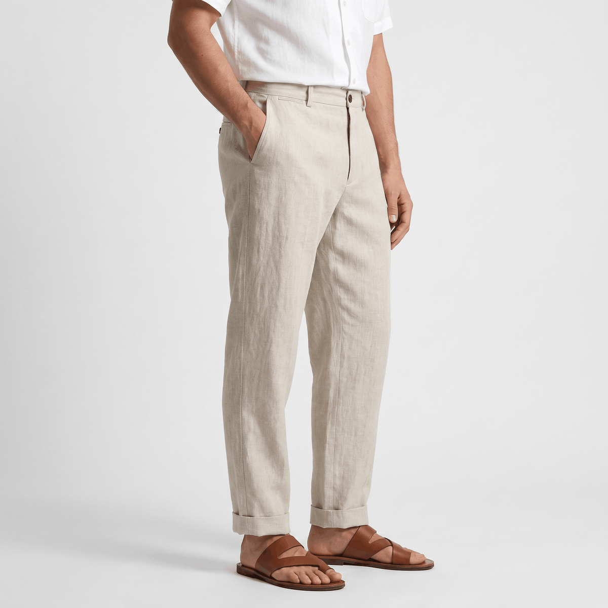 Side view of men's beige linen pants with a tailored straight-leg fit, button closure, and lightweight linen construction.