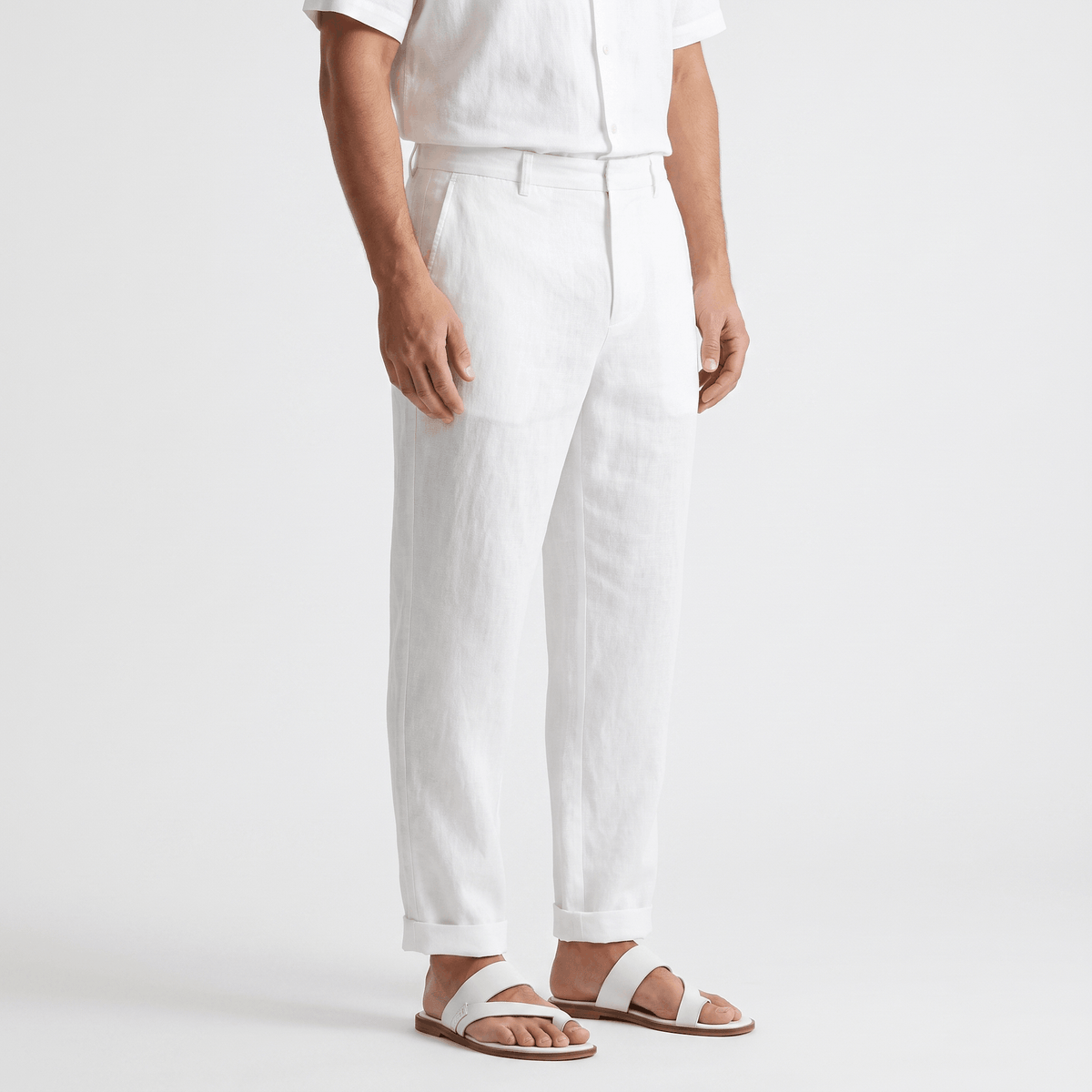 Side view of men's white linen pants with a classic straight-leg silhouette and breathable linen fabric.