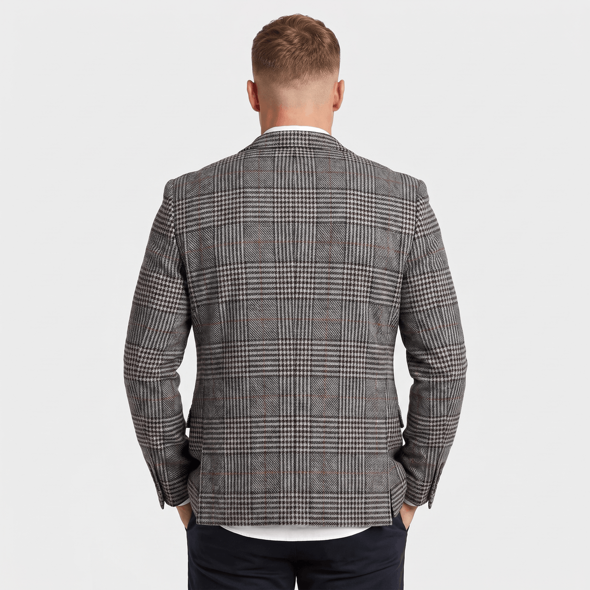Back view of a men's charcoal gray plaid tweed blazer featuring a tailored fit and classic plaid pattern.