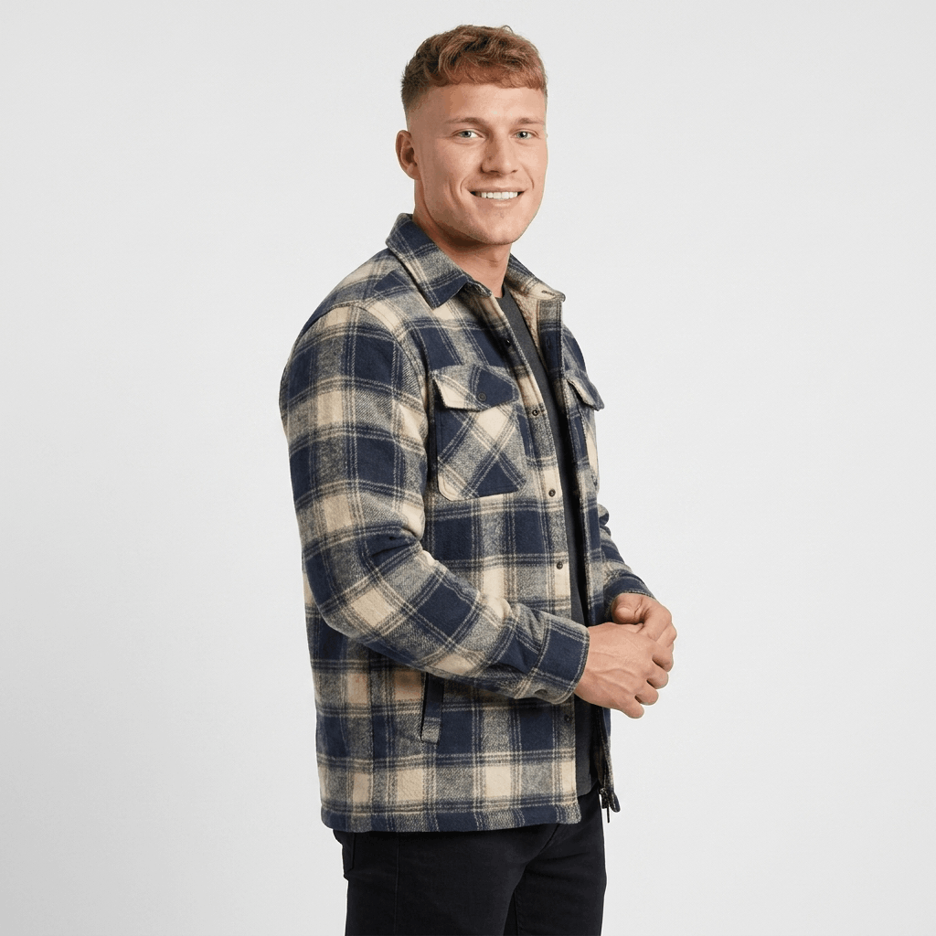 Blue and white plaid quilted-lined overshirt jacket displayed flat, featuring a pointed collar, button-front closure, chest pockets, and cream-colored lining.