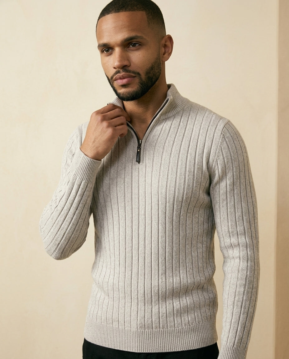 Gray ribbed quarter-zip sweater worn by a male model, featuring a high collar and long sleeves