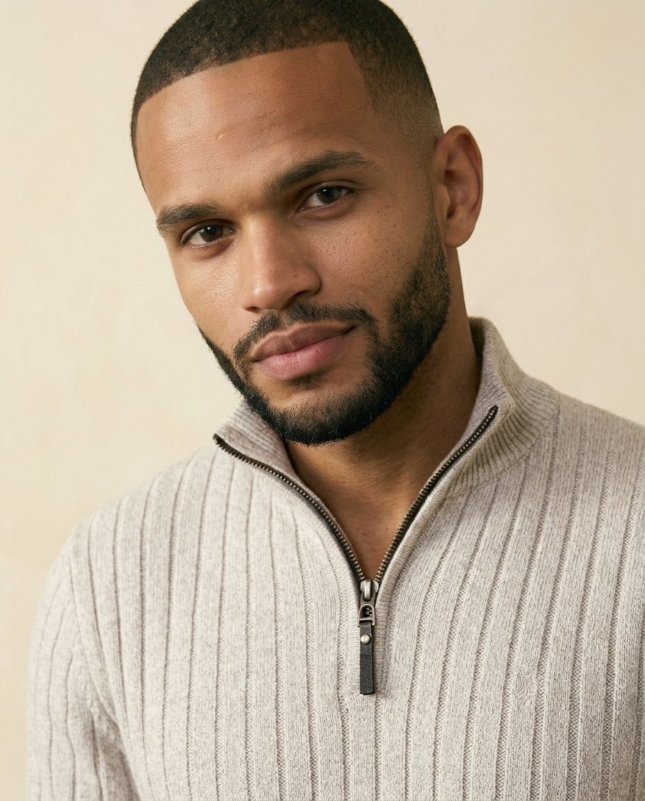 Gray ribbed quarter-zip sweater close-up showing the high collar, zipper, and textured knit fabric