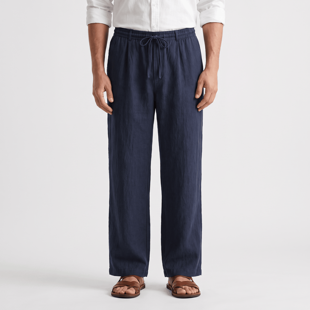 Men's navy linen drawstring pants with a relaxed straight-leg fit, elastic waistband, and lightweight linen fabric.