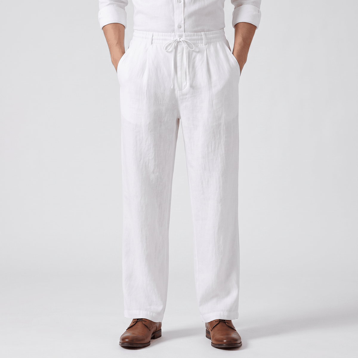 Men's white linen drawstring pants with a relaxed straight-leg fit, elastic waistband, adjustable drawstring, and side pockets.