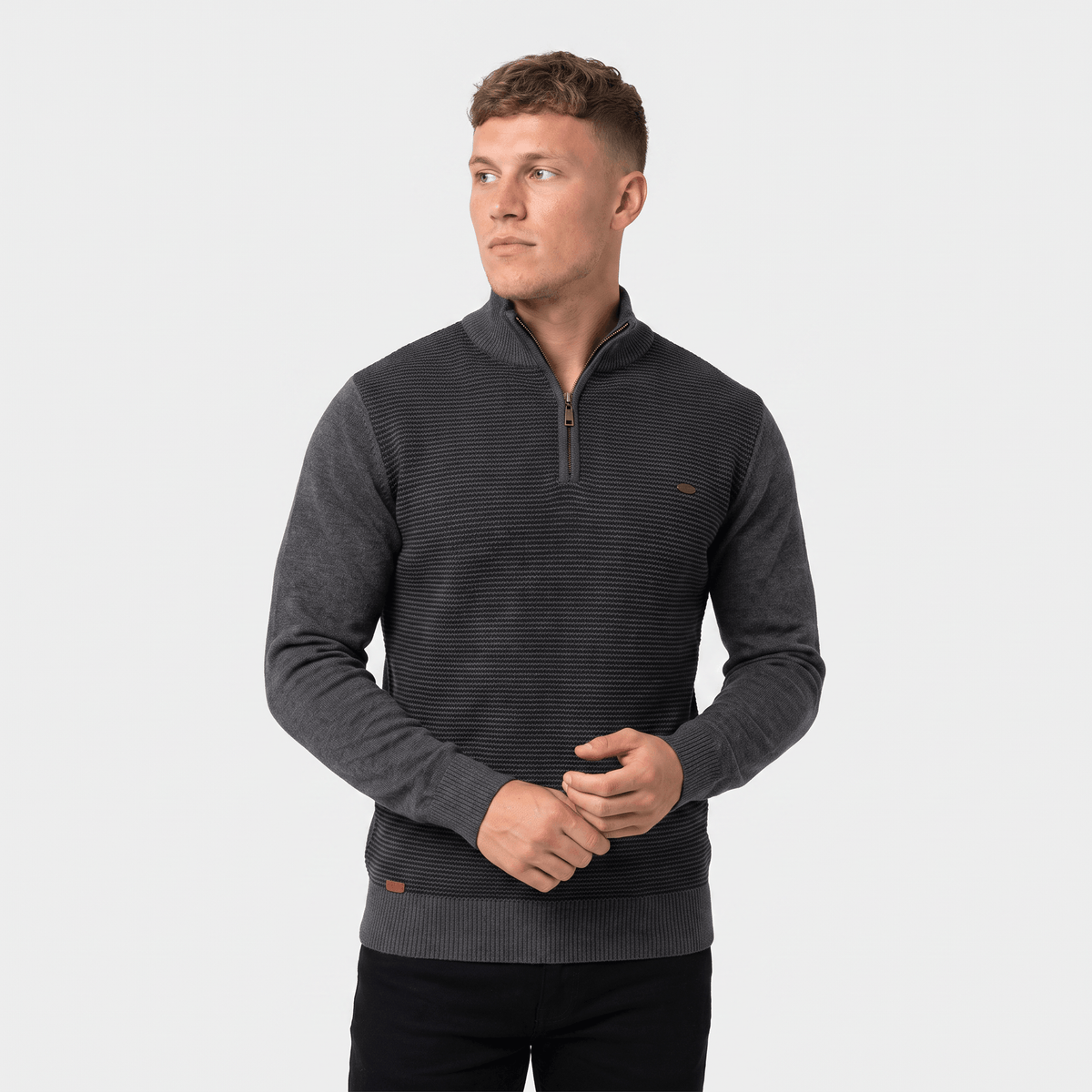 Man wearing a charcoal ribbed quarter-zip knit sweater with a stand collar, long sleeves, and a modern slim fit.
