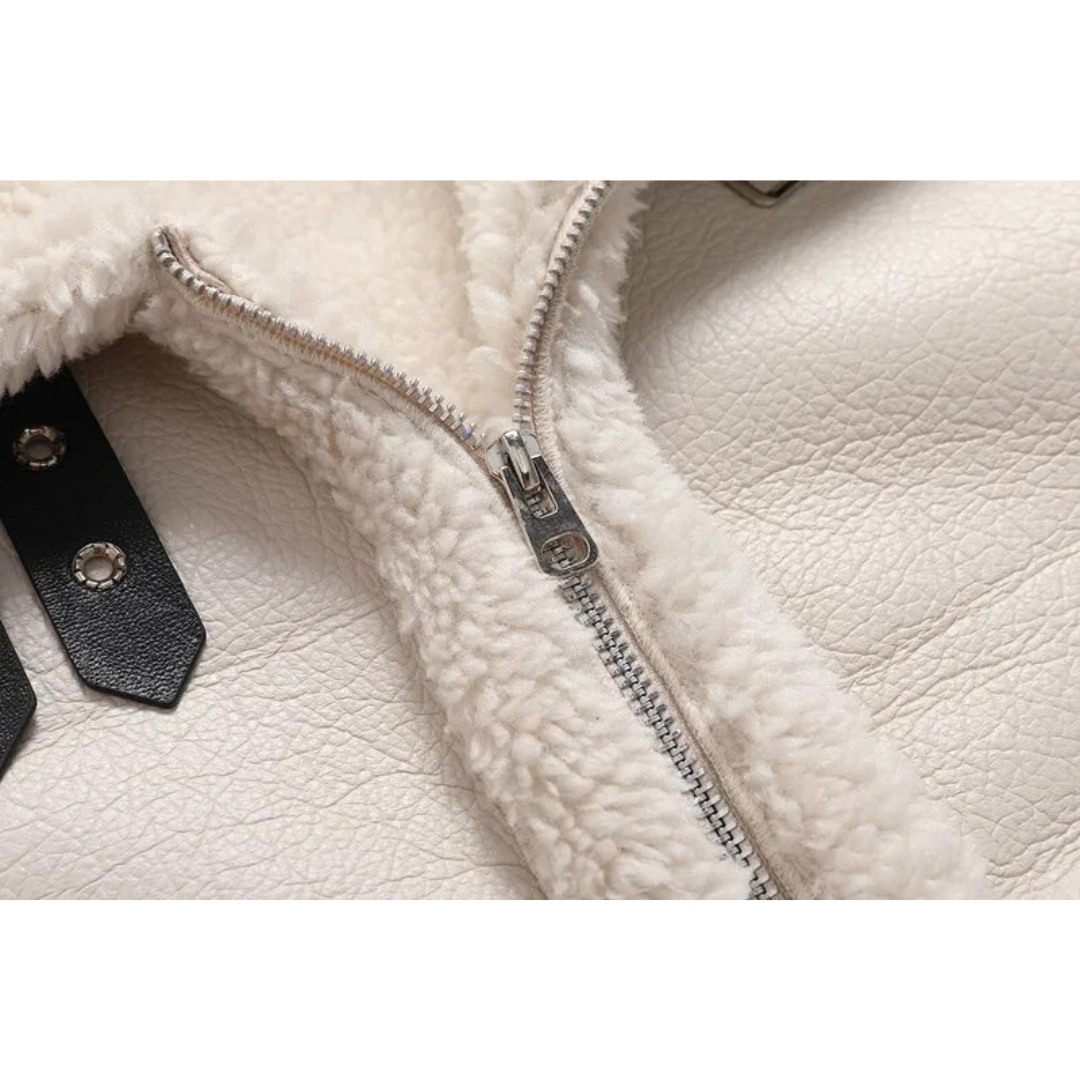 Close-up of a white shearling leather jacket showing the plush lining and soft textured interior