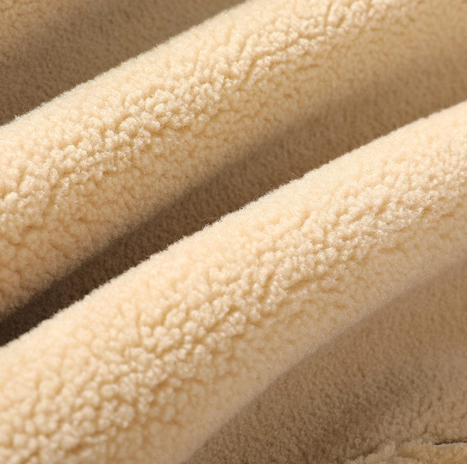 Cream sherpa fleece lining close-up showing the thick, soft texture of the jacket interior