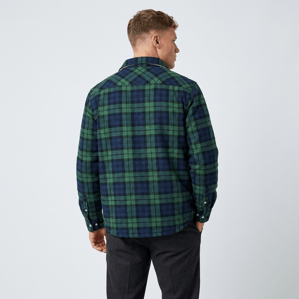 Back view of a man wearing a green and navy plaid sherpa-lined overshirt jacket with a relaxed fit.