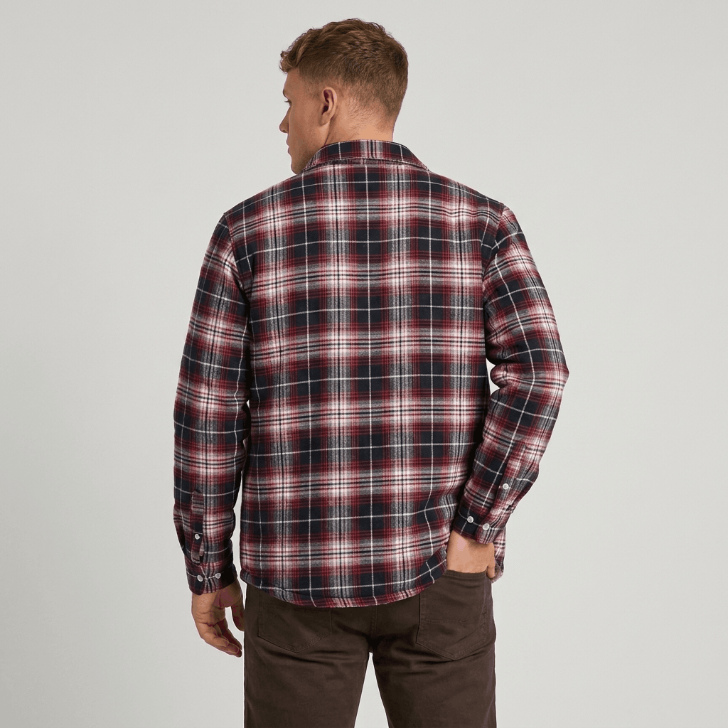 Back view of a man wearing a red, navy, and white plaid sherpa-lined overshirt jacket with a relaxed fit and long sleeves.