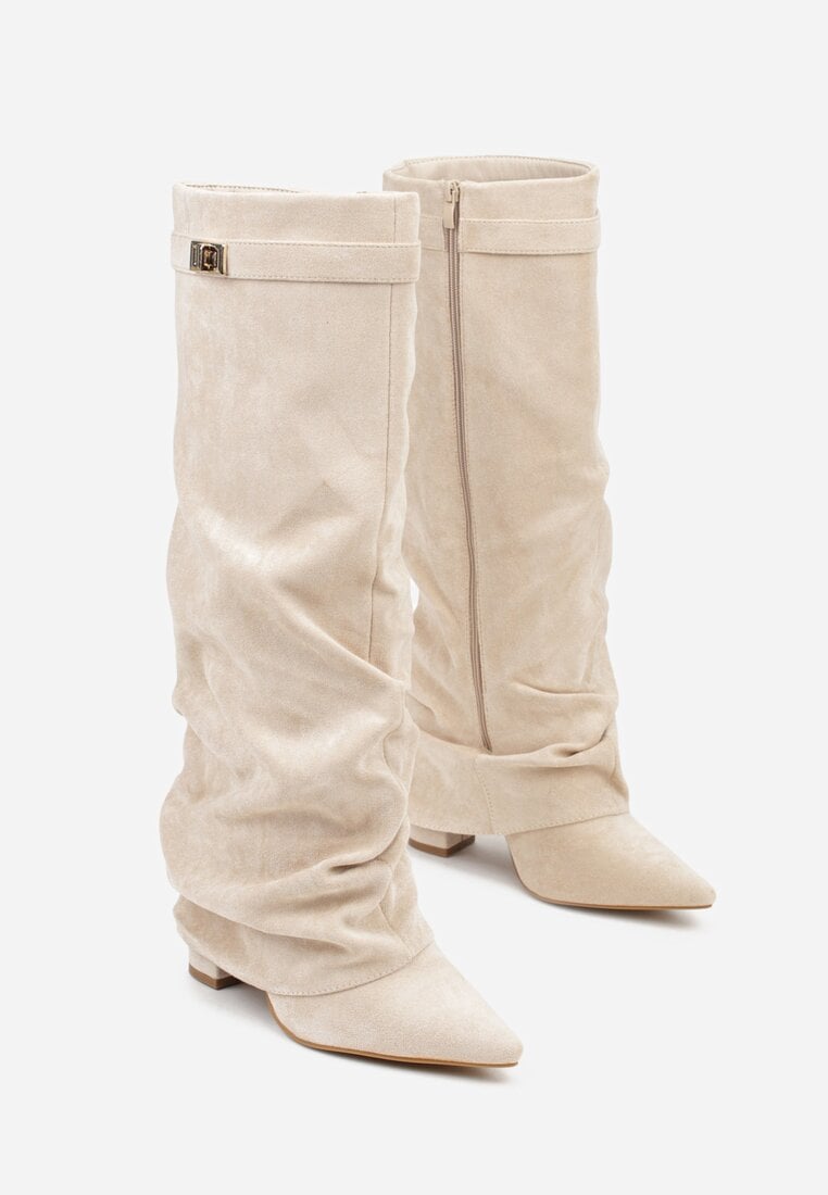 Pair of cream suede slouchy knee-high boots displayed against a white background.