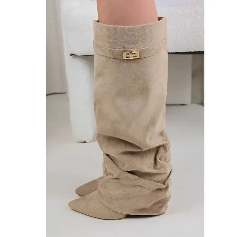 Beige suede slouchy knee-high boots worn with bare legs.