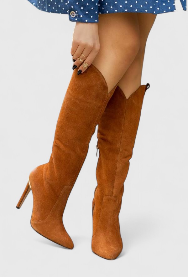 Brown suede knee-high heeled boots worn with a blue dress.