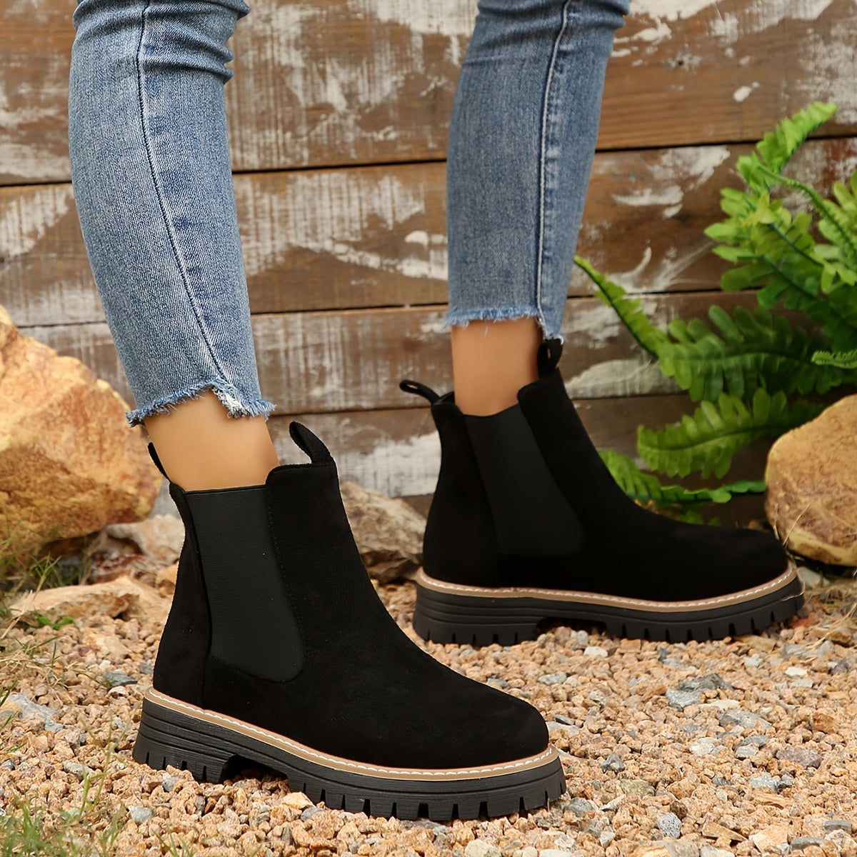 Woman in cropped jeans wearing black suede Chelsea ankle boots with elastic side gussets