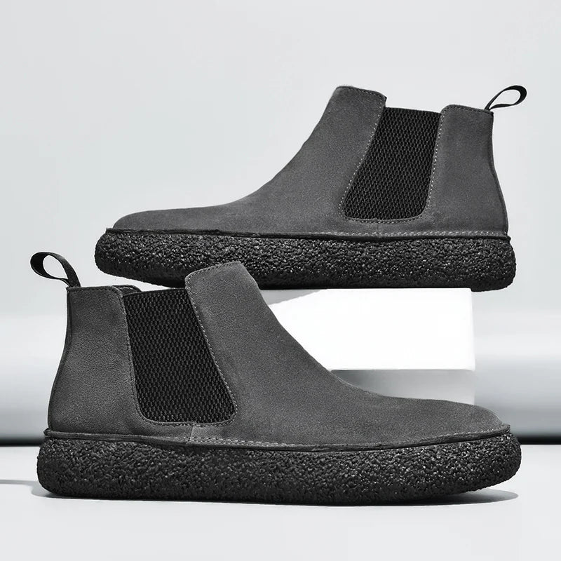 Grey suede Chelsea sneaker boots with black knit gore panels and a thick, textured black rubber sole.