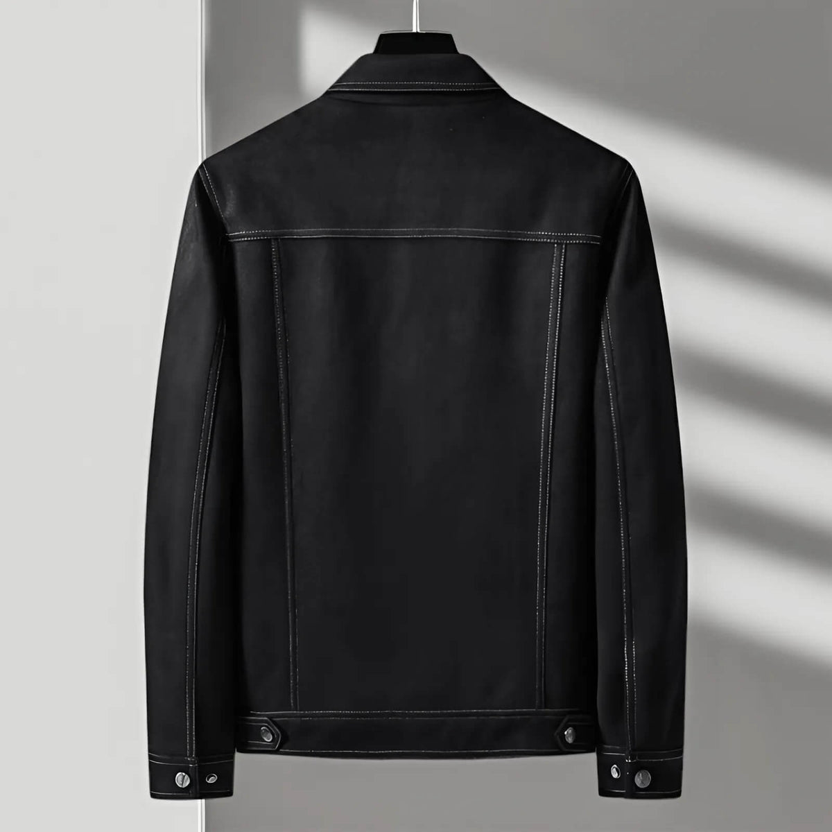 A black suede jacket for men shown from the back, featuring a tailored fit and button front