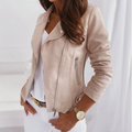 A woman wearing a beige suede jacket with an asymmetrical zip, notched lapel, and hip-length fit