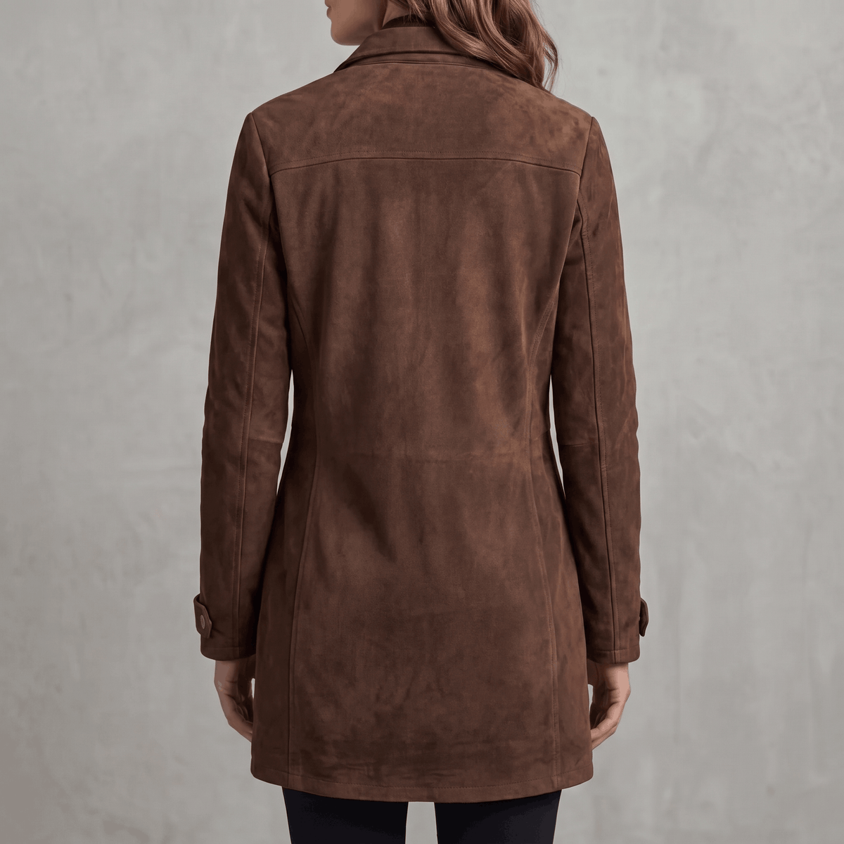 A woman wearing a brown suede jacket with a longline tailored fit, shown from the back