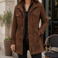 A woman wearing a brown suede jacket with a longline tailored fit, zip and snap front, flap chest pockets, and side pockets
