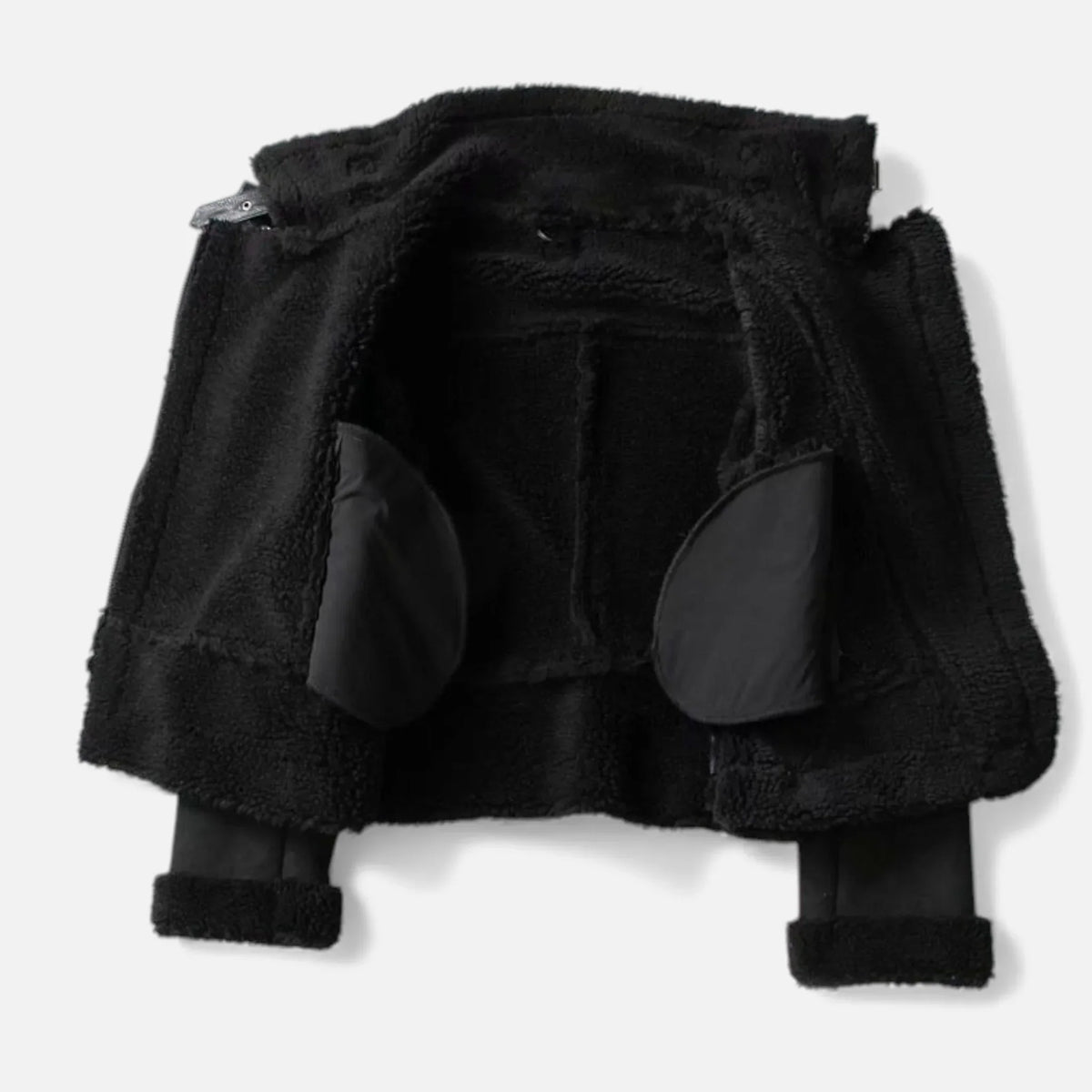A black suede shearling aviator jacket with a belted waist, asymmetric zip front, and plush shearling lining, shown flat