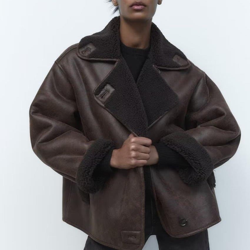 Dark Brown suede shearling jacket worn by a women with a boxy fit, plush lining, and aviator style