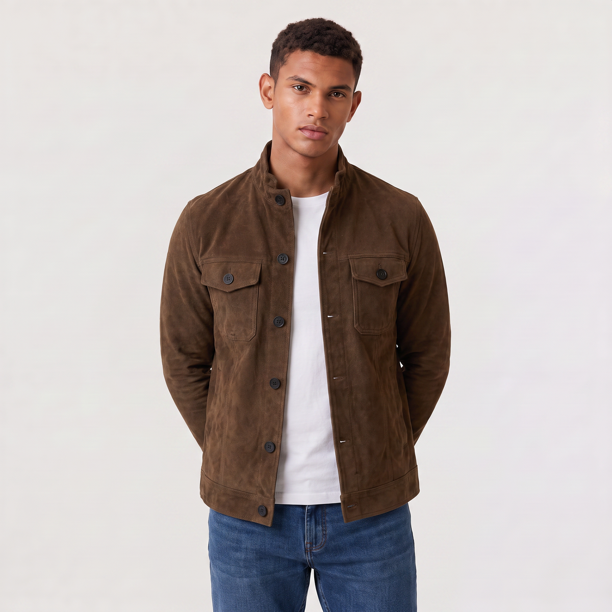 A man wearing an olive green suede trucker jacket with a button front, stand collar, and chest pockets