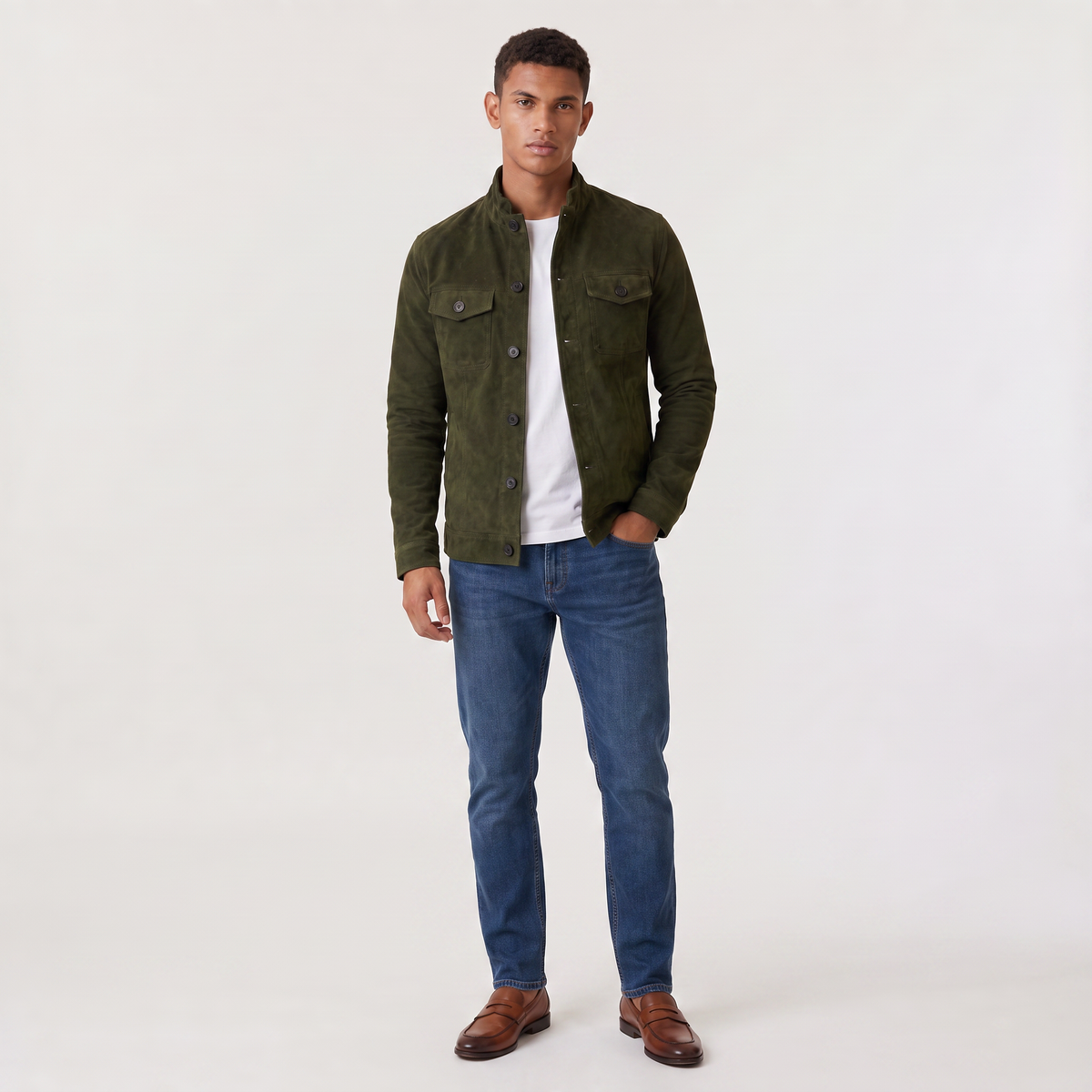 A man wearing an olive green suede trucker jacket with a button front, stand collar, and chest pockets, full-body view