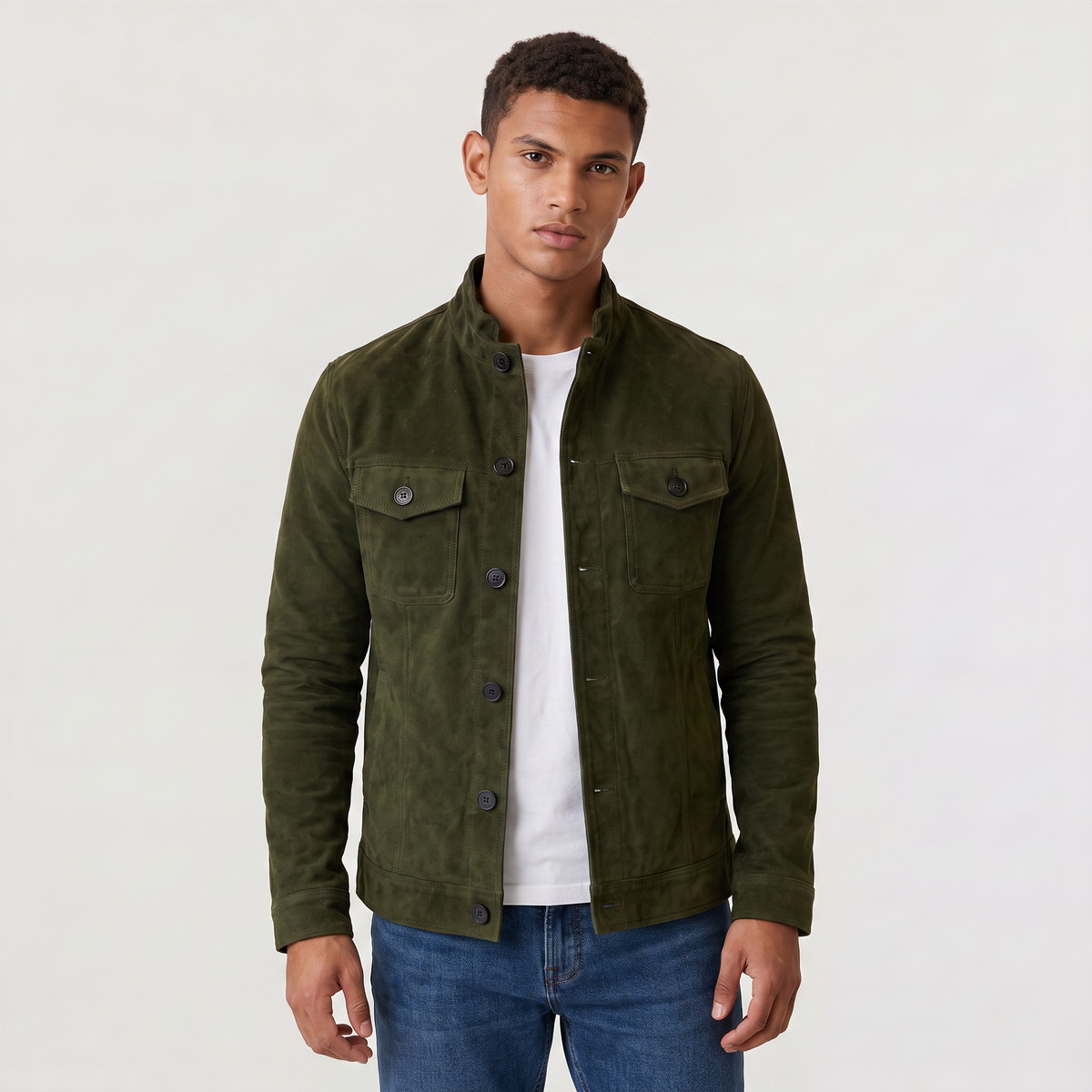 A man wearing an olive green suede trucker jacket with a button front, stand collar, and chest pockets