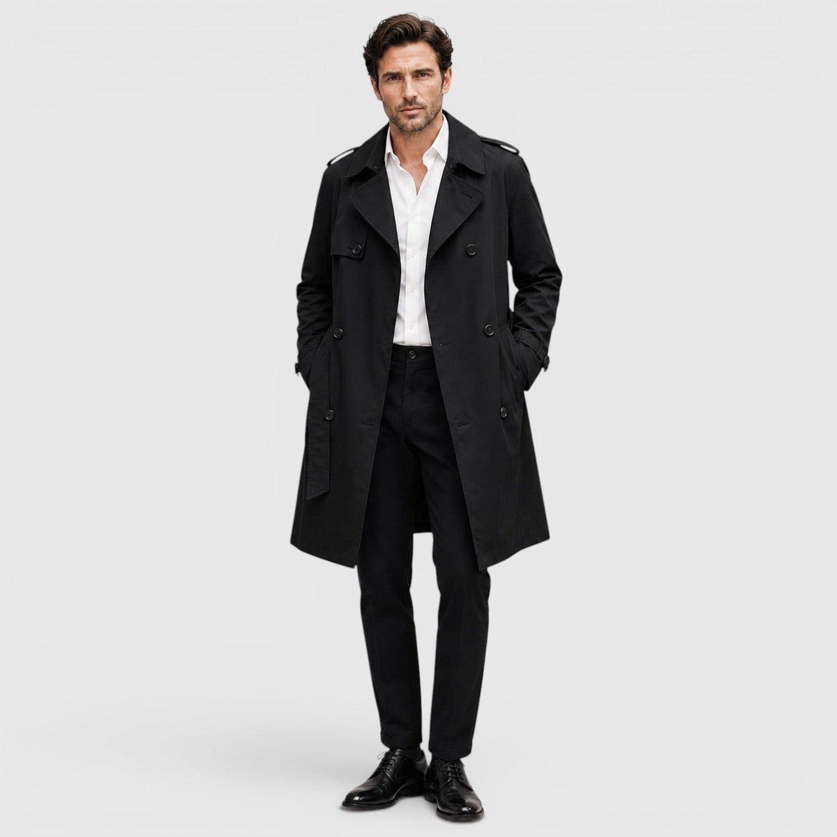 A man wearing a rust brown tailored double-breasted trench coat with an adjustable belt and notch lapel