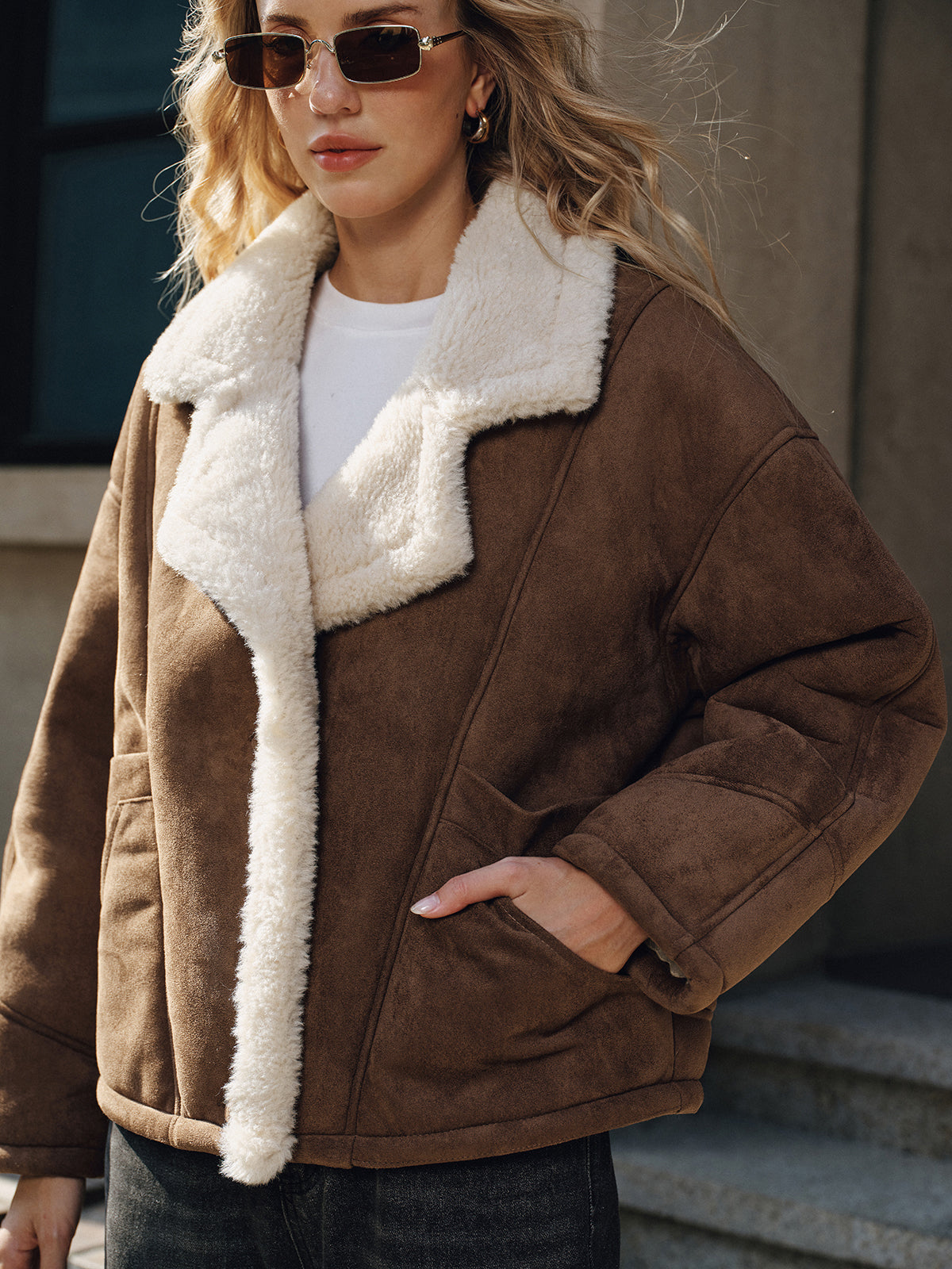 Brown thickened wool shearling jacket worn by a female model, featuring a boxy fit, plush collar, and two-button front
