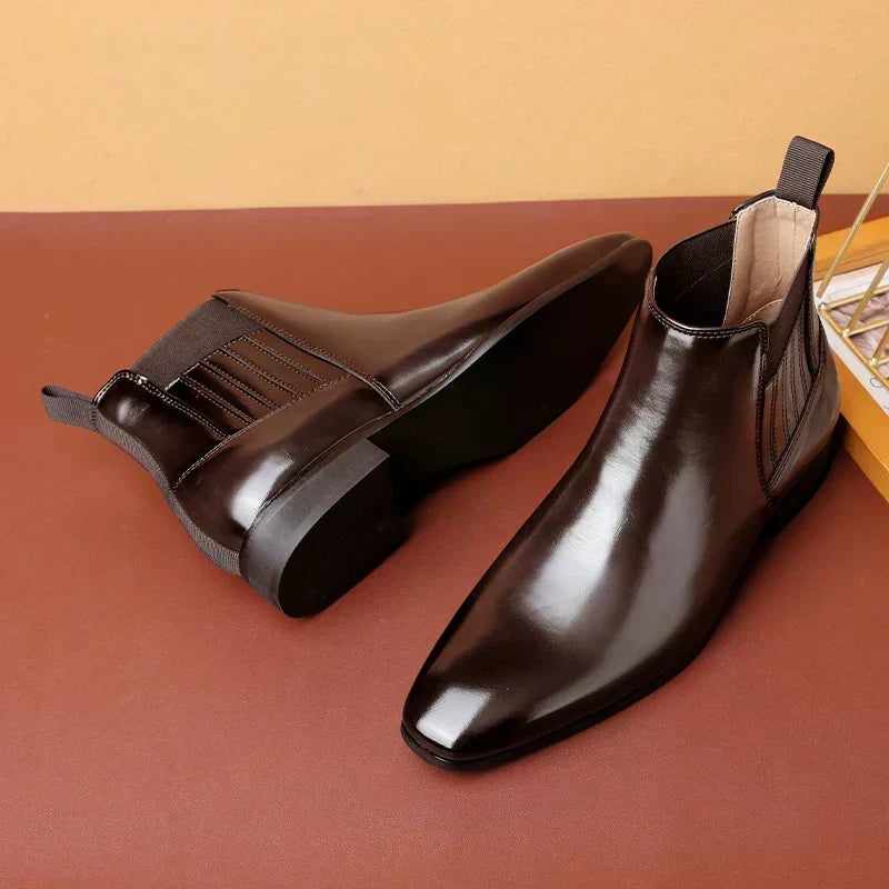 Dark brown vegan leather Chelsea boot for men beside a second boot turned to show the sole and stacked heel