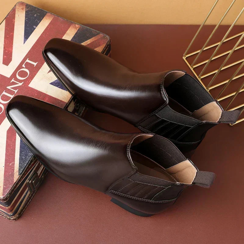 Dark brown pointed-toe Chelsea boots for men seen from above, showing the elastic side panel and stacked heel