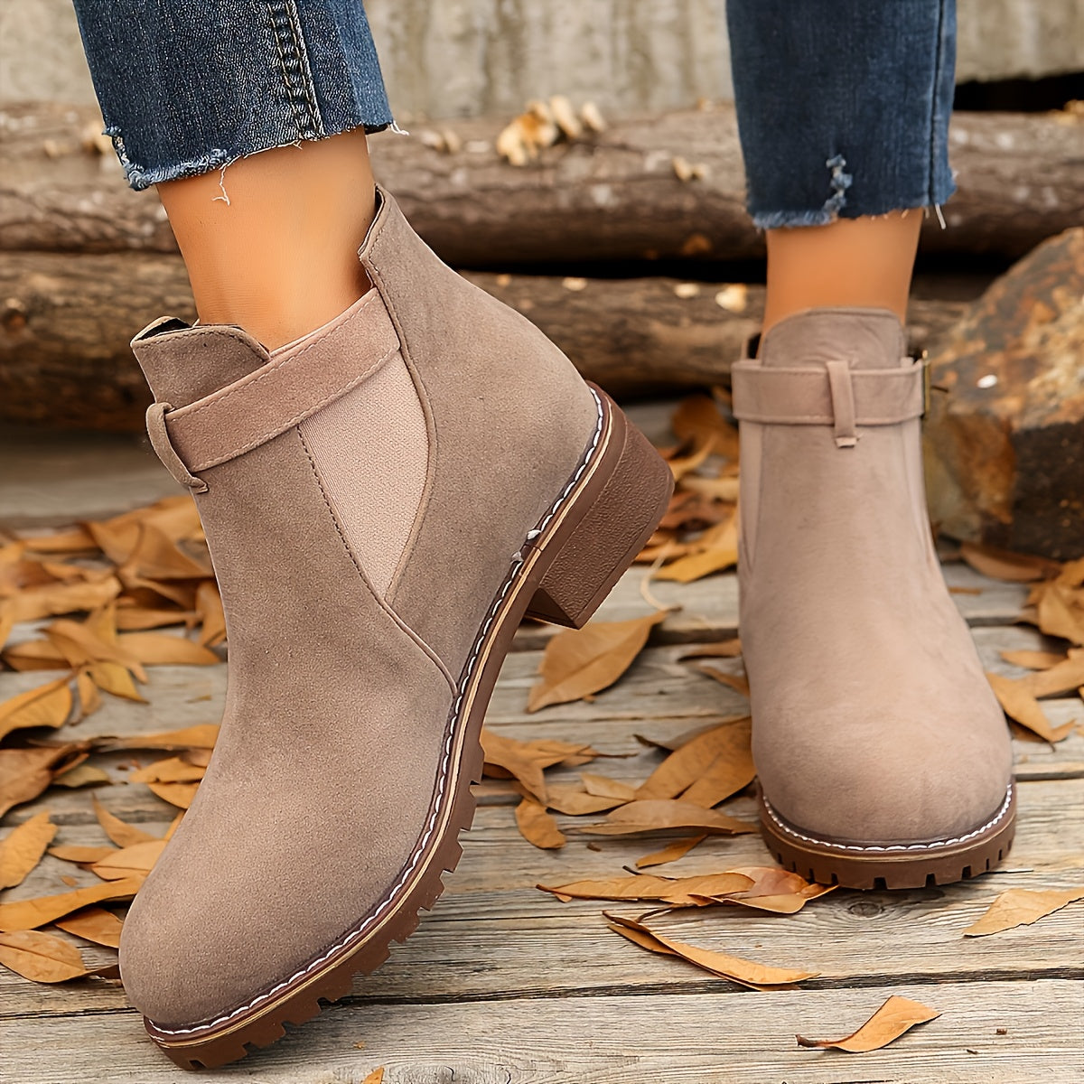 Taupe vegan suede Chelsea ankle boots for women with buckle ankle strap, worn on autumn leaves