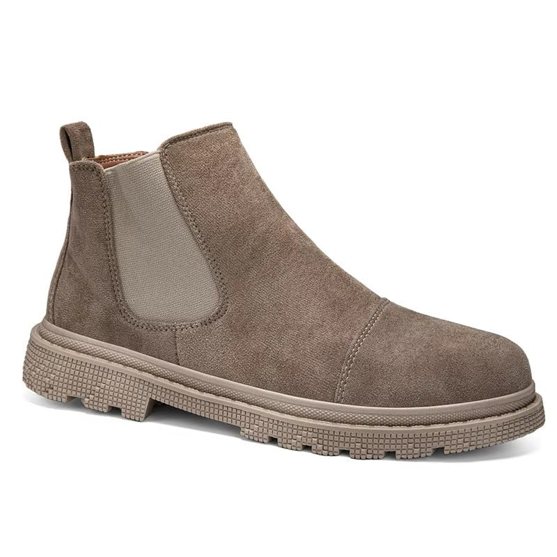 Taupe vegan suede Chelsea boots with lug sole worn with cuffed cream trousers on a cream backdrop
