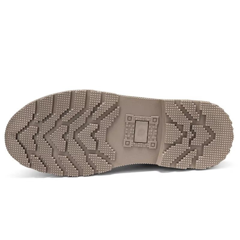 Underside of the lug sole on vegan suede Chelsea boots for men, showing the deep tread pattern