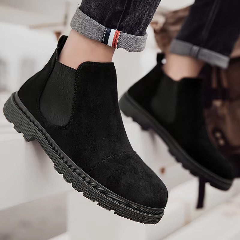 Close-up of black vegan suede Chelsea boots for men showing the elastic side panel and lug sole